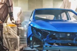 Car being painted on an assembly line