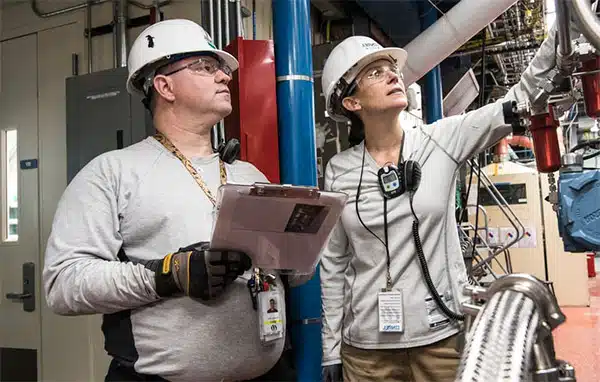 team looking at production schedule impact in factory